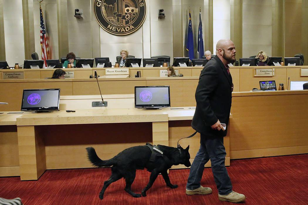 U.S. Army veteran, Michael Neil, accompanied by his service dog Yamas, leaves the podium after speaking during the City Council meeting at Las Vegas City Hall Wednesday, Nov. 15, 2017. Neil suppor ...