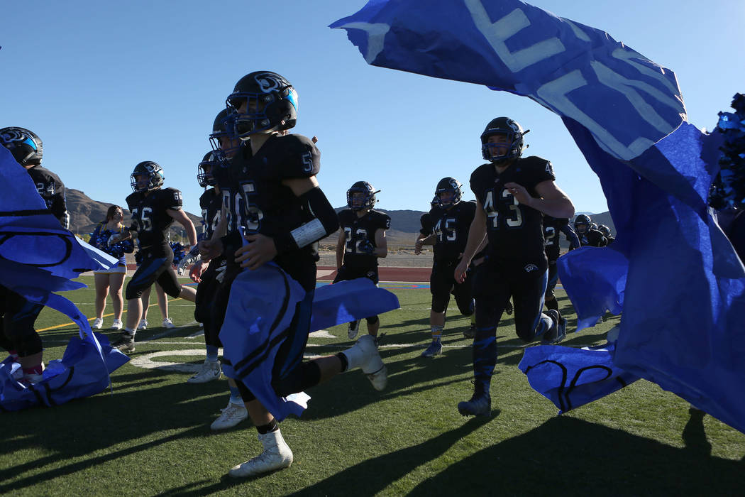 Pahranagat Valley players run on to the field for the class A state championship game against Spring Mountain at Indian Springs High School in Indian Springs, Saturday, Nov. 18, 2017. Pahranagat V ...