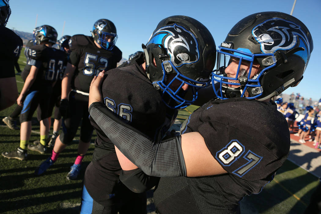 Pahranagat Valley players Tyler Bundy (66) and Ryan Jorgensen (87) embrace after the class A state championship game against Spring Mountain at Indian Springs High School in Indian Springs, Saturd ...