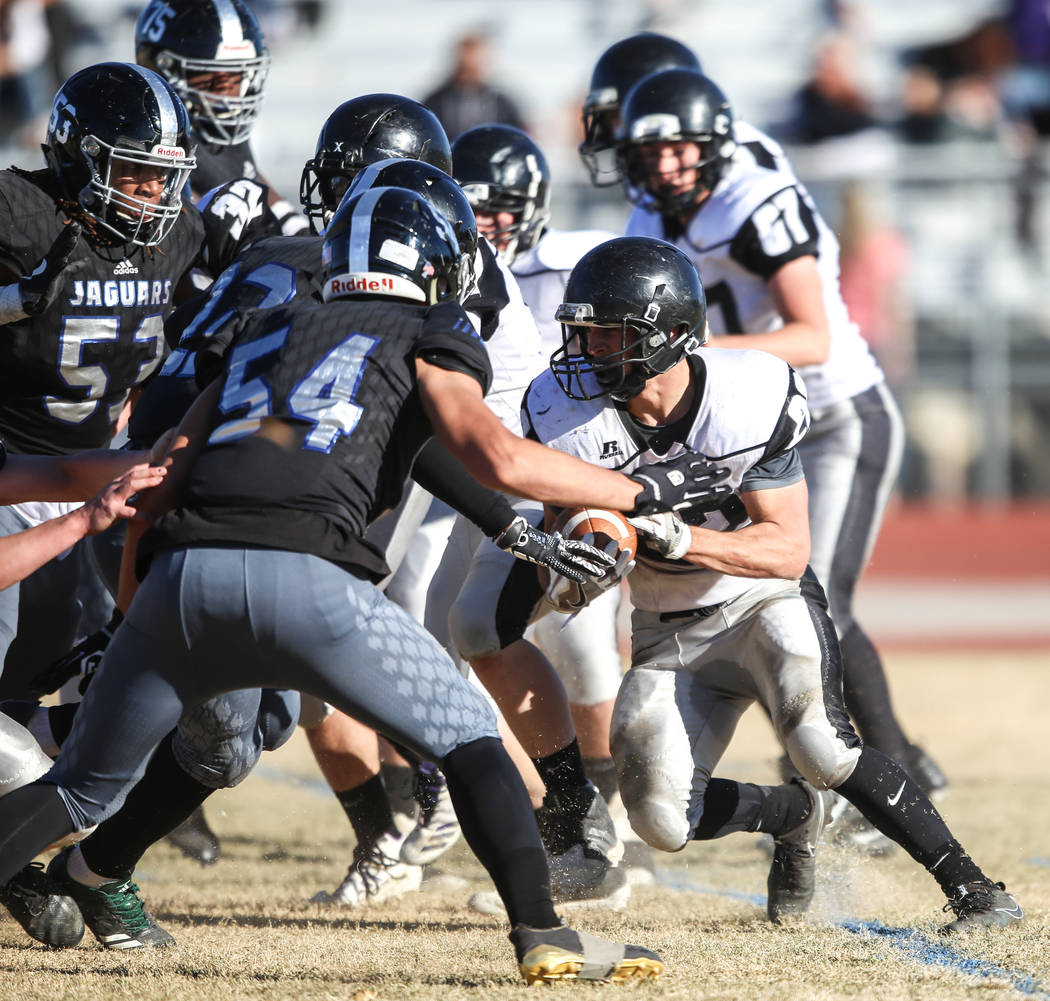 Spring Creek's Jason Painter (22), right, runs the ball against Desert Pines during the second quarter of the Class 3A State football game at Desert Pines High School in Las Vegas, Saturday, Nov.  ...