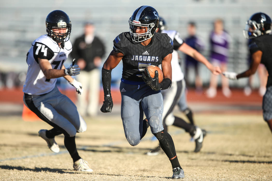 Desert Pines' Jordan Howden (5) runs the ball against Spring Creek during the fourth quarter of the Class 3A State football game at Desert Pines High School in Las Vegas, Saturday, Nov. 18, 2017.  ...