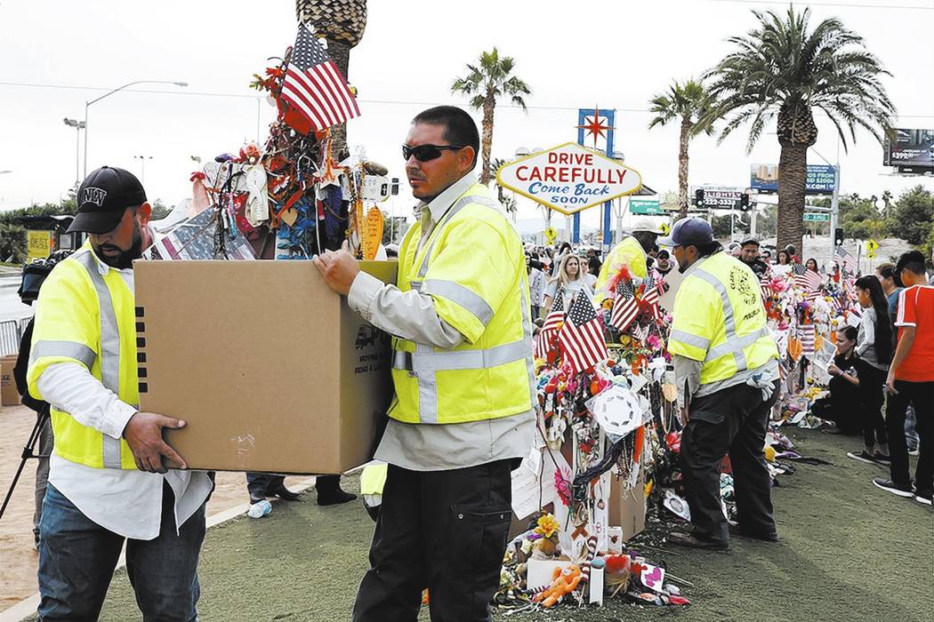 Clark County employees box up crosses and items from the Route 91 Harvest festival memorial and load them onto trucks, which will take the items to the Clark County Museum at 1830 S. Boulder Highw ...