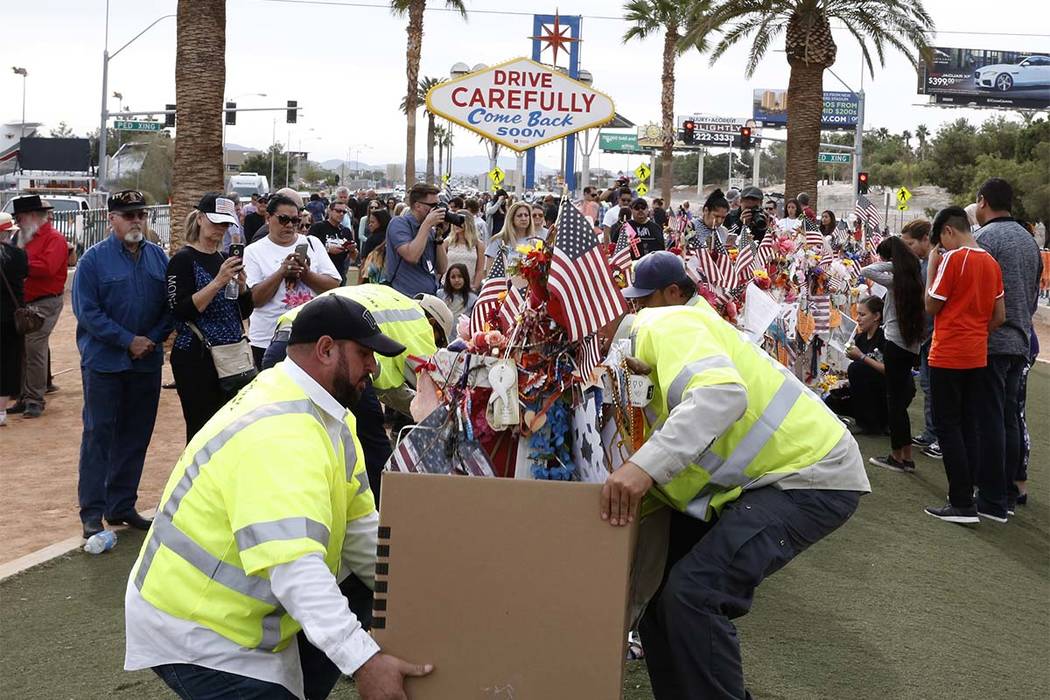 Clark County employees box up crosses and items from the Route 91 Harvest festival memorial and load them onto trucks, which will take the items to the Clark County Museum at 1830 S. Boulder Highw ...