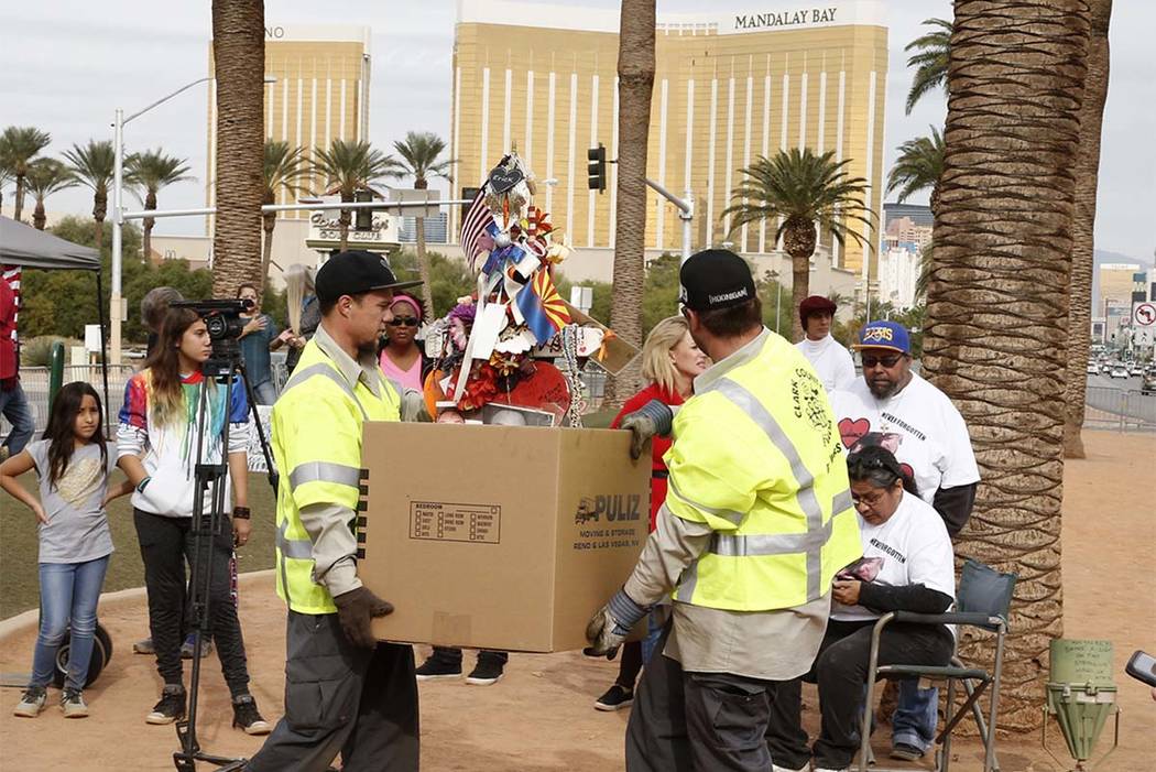 Clark County employees box up crosses and items from the Route 91 Harvest festival memorial and load them onto trucks, which will take the items to the Clark County Museum at 1830 S. Boulder Highw ...