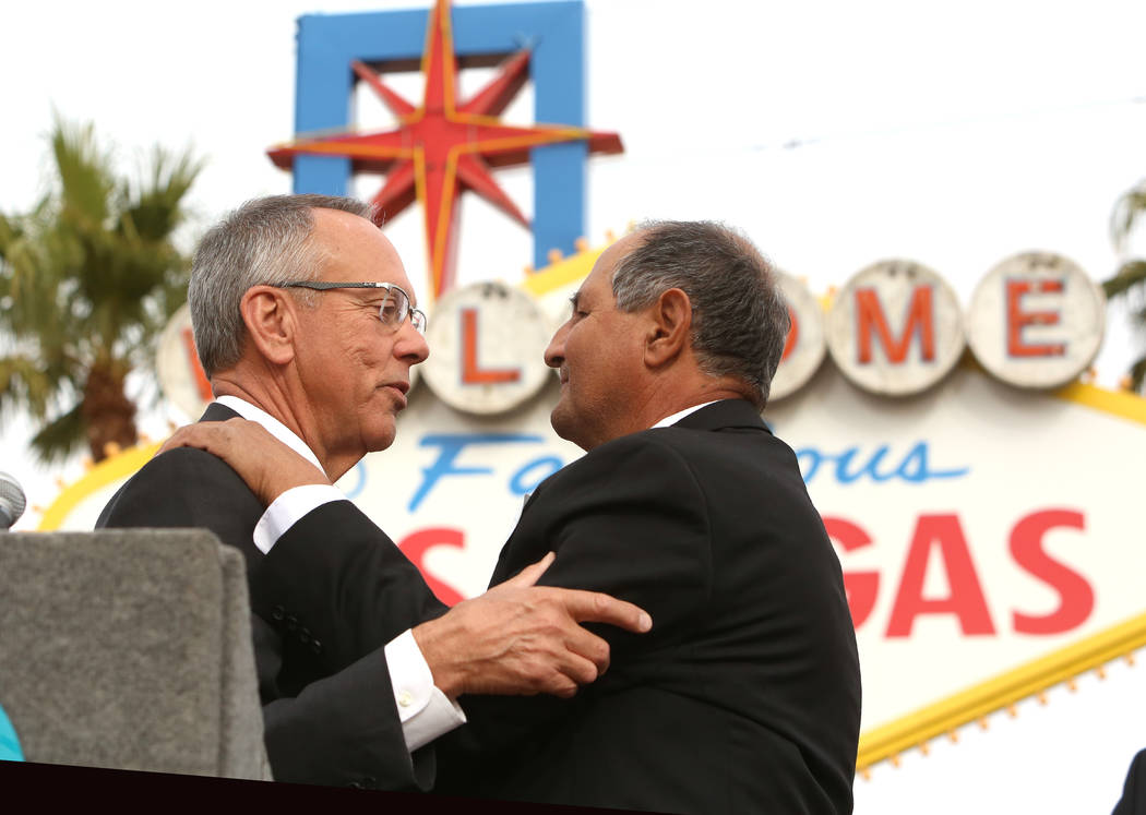 Jim Gibson, Clark County Commissioner, left, congratulates Greg Zanis after declaring Sunday ҇reg Zanis DayӠat the Route 91 Harvest memorial at the Welcome to Fabulous Las Vegas sign S ...