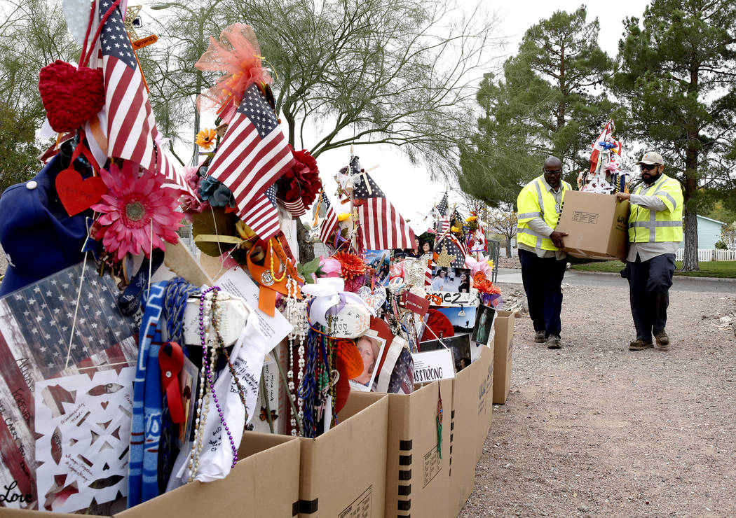 Clark County employees unload crosses and items from a truck at the clark County Museum in Henderson Sunday, Nov. 12, 2017. Fifty eight crosses and items that were erected in honor of the Oct. 1 s ...