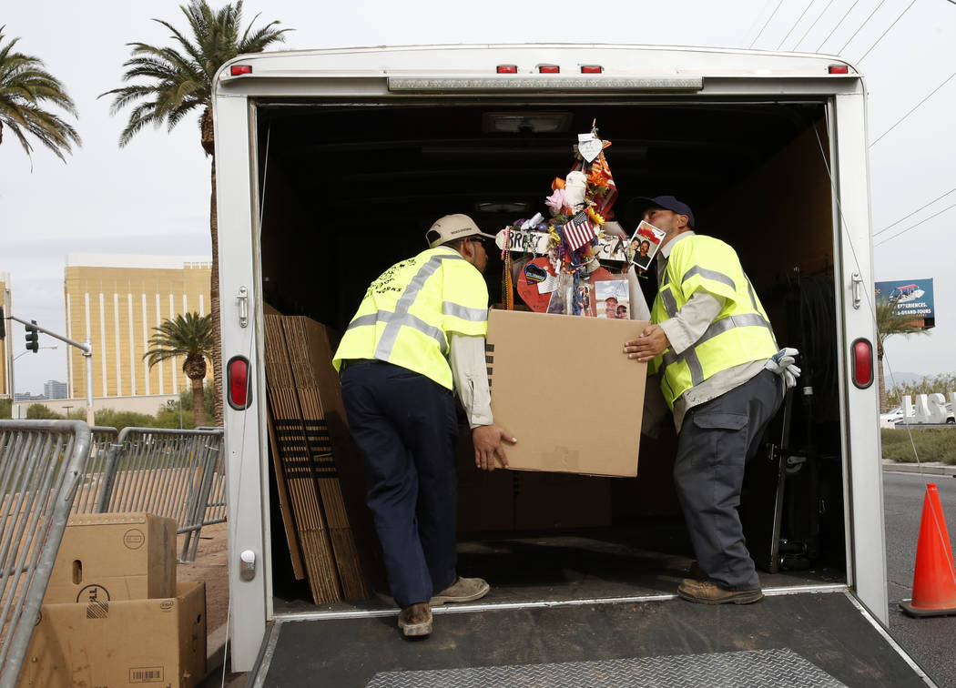 Clark County employees load crosses and items onto a truck at the Route 91 Harvest memorial at the Welcome to Fabulous Las Vegas sign Sunday, Nov. 12, 2017. Fifty eight crosses and items that were ...