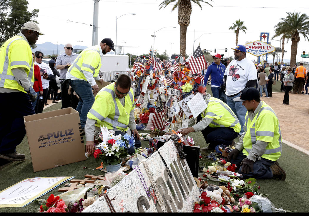 Clark County employees box up crosses and items from the Route 91 Harvest festival memorial and load them onto trucks at the Route 91 Harvest memorial at the Welcome to Fabulous Las Vegas sign Nov ...