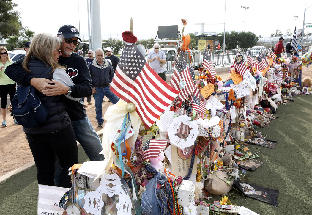 Chris Davis and his wife Debbie visit a memorial cross for their daughter Neysa Tonks at the Welcome to Fabulous Las Vegas sign Sunday, Nov. 12, 2017. Fifty eight crosses and items that were erect ...