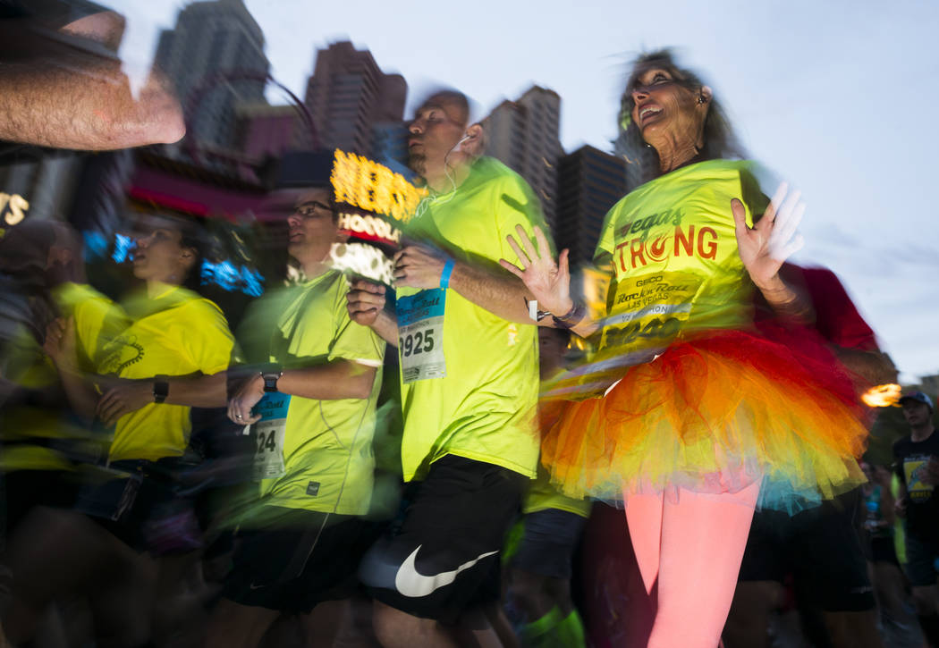 Half marathon participant Kandice Westenberger of Redlands, Calif., right, heads out from the start of the Rock 'n' Roll Marathon in Las Vegas on Sunday, Nov. 12, 2017. Chase Stevens Las Vegas Rev ...