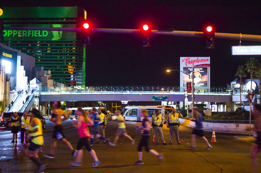 Las Vegas police officers watch as race participants pass by Tropicana Avenue during the Rock 'n' Roll Marathon in Las Vegas on Sunday, Nov. 12, 2017. Chase Stevens Las Vegas Review-Journal @csste ...