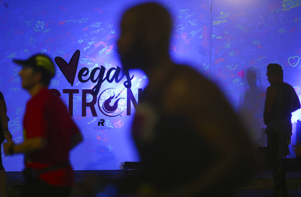 Race participants pass a memorial wall in honor of victims of the Oct. 1 shooting during the Rock 'n' Roll Marathon in Las Vegas on Sunday, Nov. 12, 2017. Chase Stevens Las Vegas Review-Journal @c ...