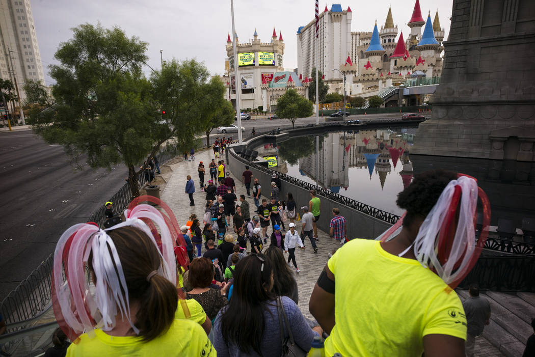 Amanda Bailey, left, and Girldy Janiton (cq), both of the Montreal, Canada area, take in the scene before the start of the Rock 'n' Roll Marathon outside of the New York New York in Las Vegas on S ...