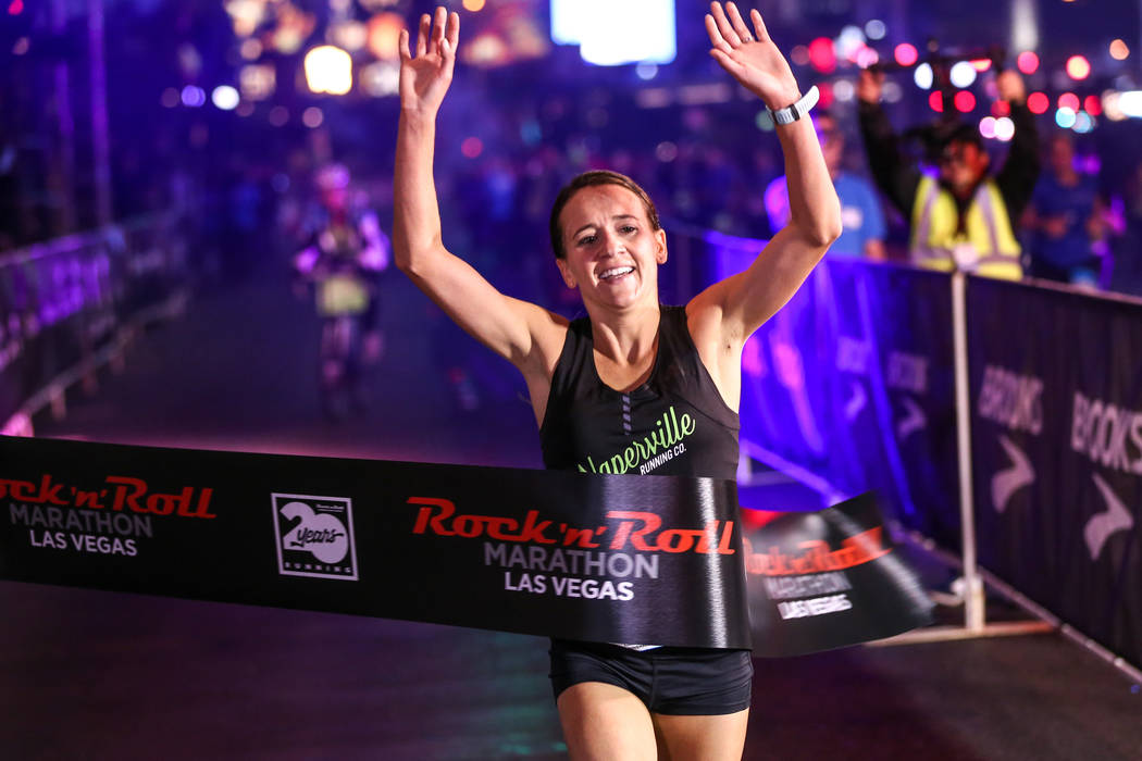 Marisa Hird of Naperville, Illinois crosses the finish line winning first place at the women's marathon run of the Rock 'n' Roll Las Vegas Marathon along the Strip near The Mirage in Las Vegas, Su ...