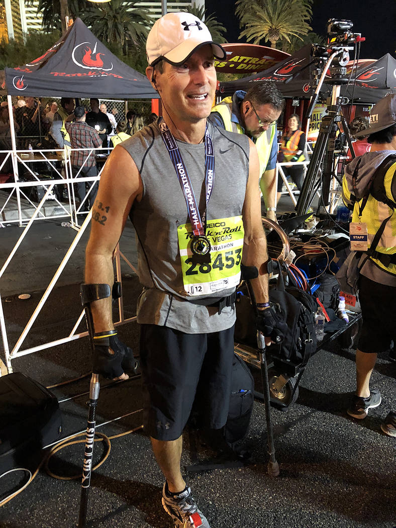 Larry Chloupek of Scottsdale, Arizona, poses after finishing the half marathon on Sunday. (Betsy Helfand/Las Vegas Review-Journal)