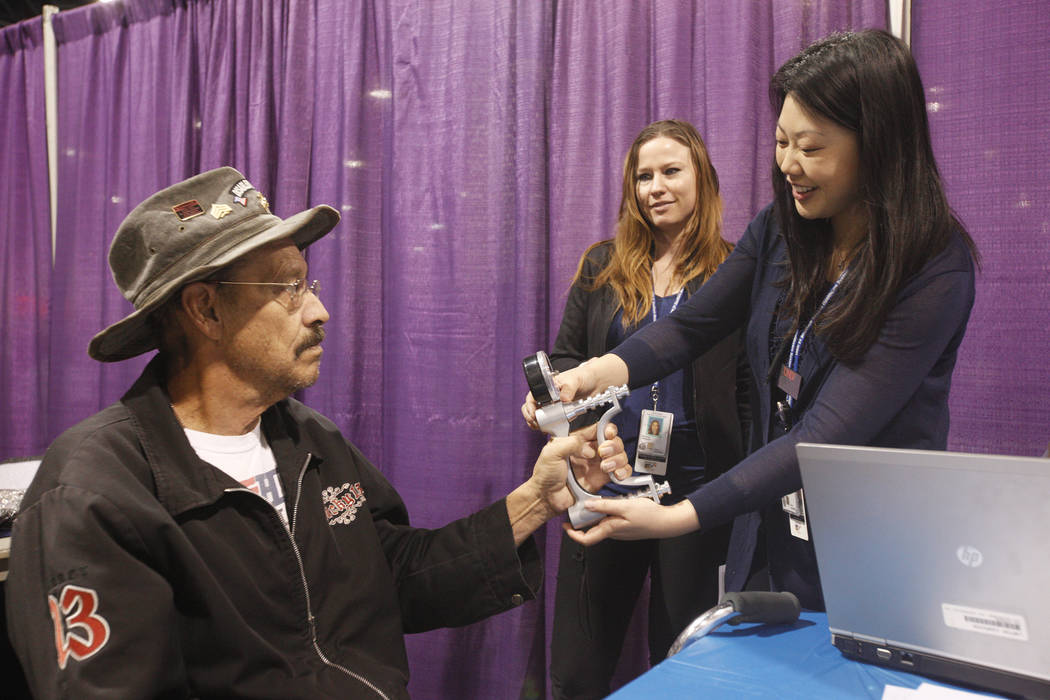 Veteran Richard Palmer has his hand grip strength tested by Sora Julie Lee at Project Homeless Connect, a service and resource fair for people who are homeless or at-risk at Cashman Center in Las ...