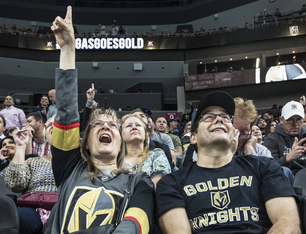 Caroline Furlong, left, and husband Mike cheer for the Vegas Golden Knights during their first home preseason game with the Los Angeles Kings on Wednesday, Sept. 26, 2017, at T-Mobile Arena, in La ...