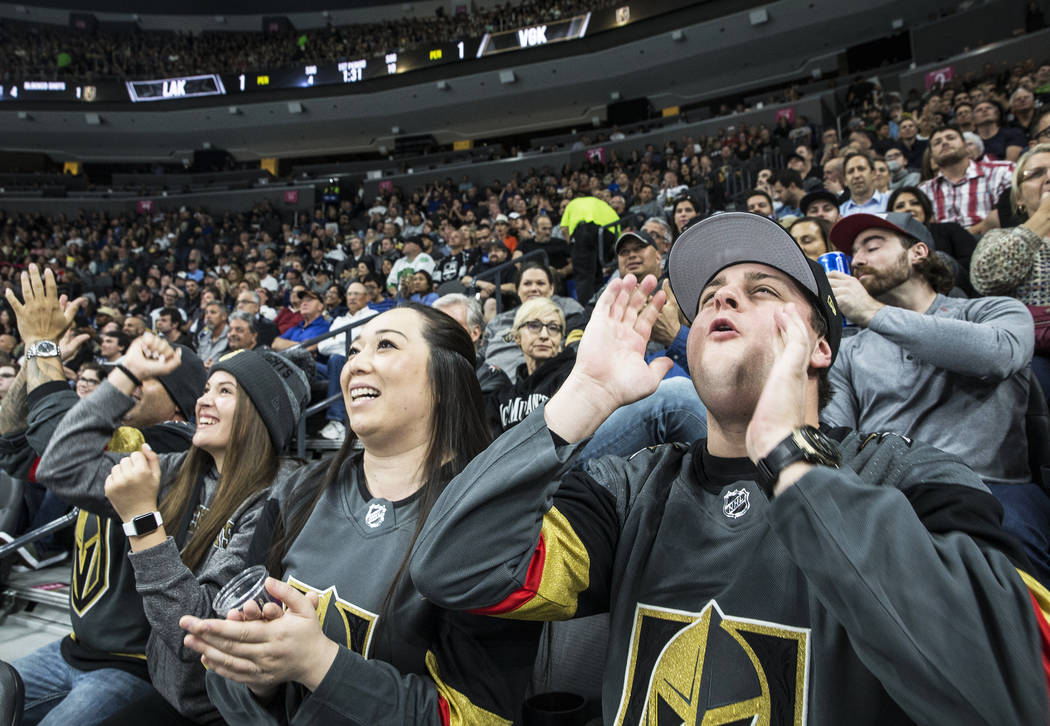 Zach Ramsey, right, Jessica Powman and Talisia Sandoval cheer for the Vegas Golden Knights during their first home preseason game with the Los Angeles Kings on Wednesday, Sept. 26, 2017, at T-Mobi ...