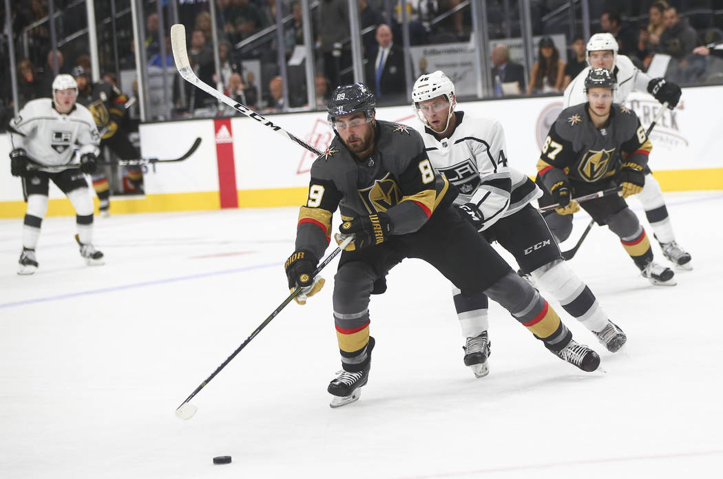 Golden Knights' Alex Tuch (89) goes after the puck against Los Angeles Kings' Spencer Watson (46) during an NHL preseason hockey game at T-Mobile Arena in Las Vegas on Tuesday, Sept. 26, 2017. Cha ...