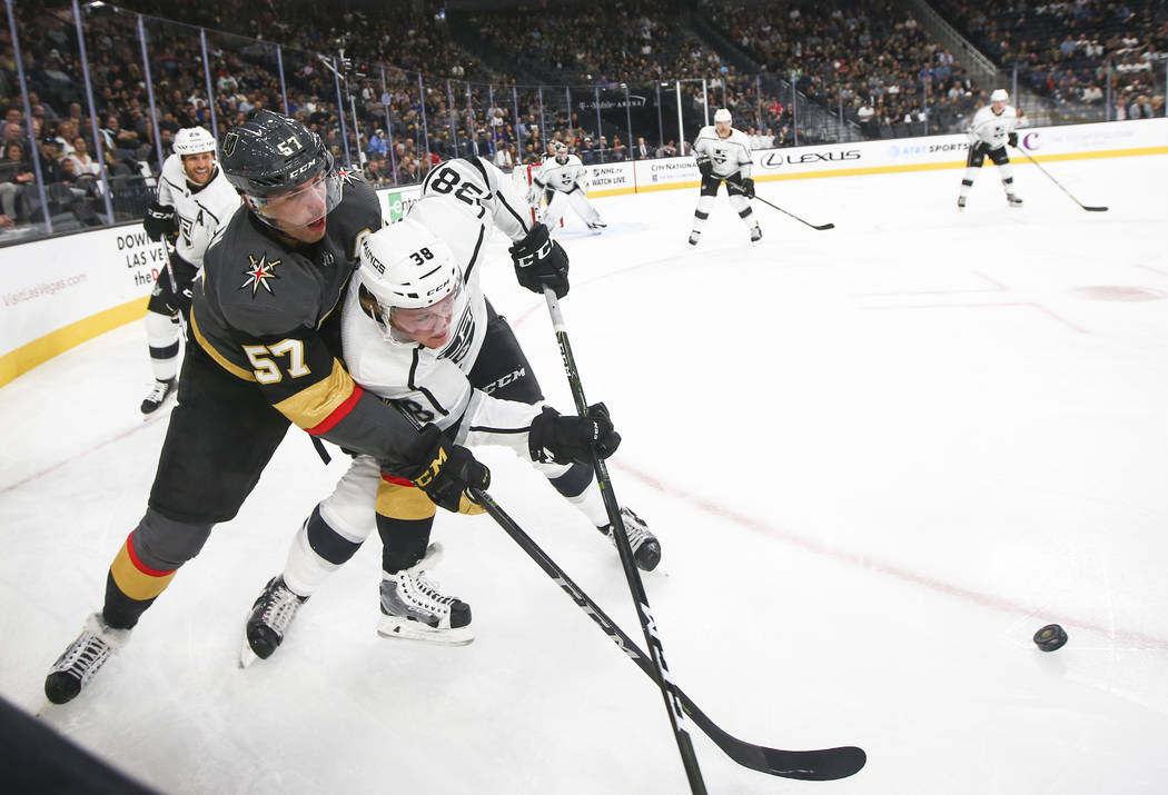 Golden Knights' David Perron (57) battles for the puck against Los Angeles Kings' Paul LaDue (38) during an NHL preseason hockey game at T-Mobile Arena in Las Vegas on Tuesday, Sept. 26, 2017. The ...