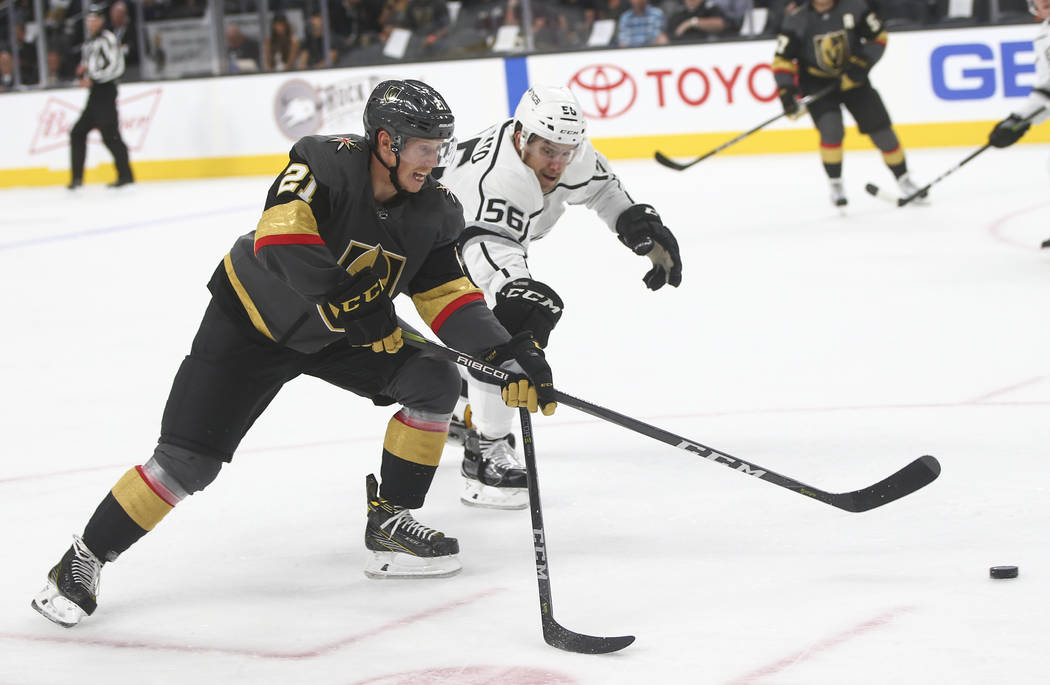Golden Knights' Cody Eakin (21) guides the puck as Los Angeles Kings' Kurtis MacDermid (56) defends during an NHL preseason hockey game at T-Mobile Arena in Las Vegas on Tuesday, Sept. 26, 2017. T ...
