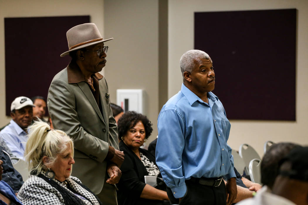 Joel Brown, 75, left, and Henry Thorns, 57, right, both of Las Vegas, wait in line to speak during a town hall meeting at the Pearson Community Center discussing the future of the Moulin Rouge sit ...