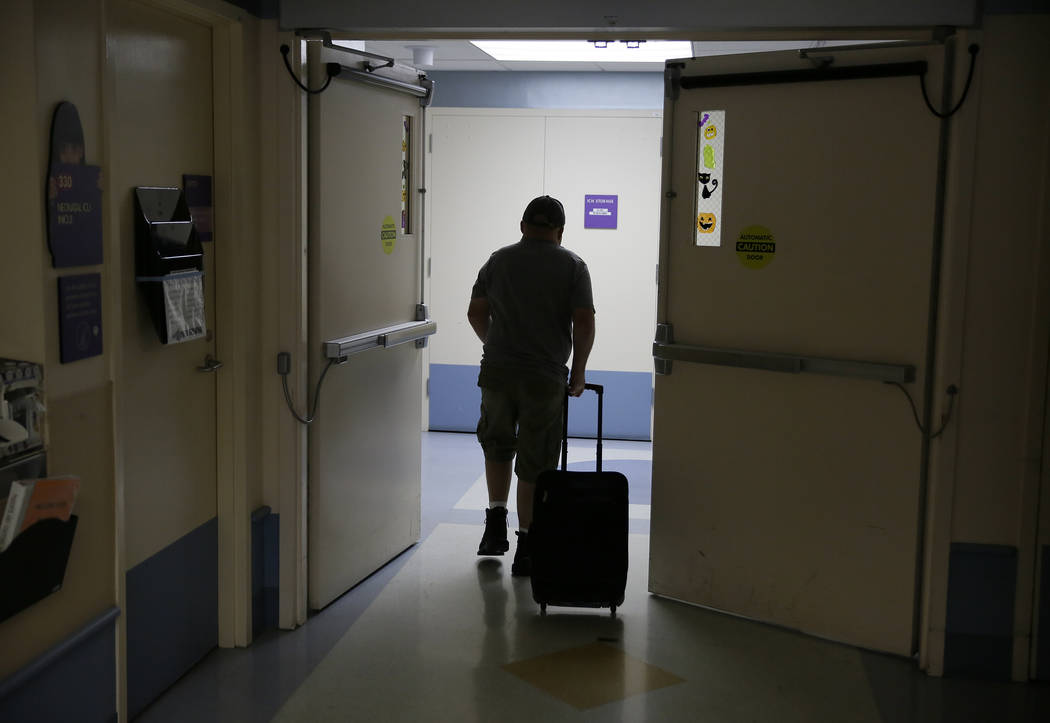 In this photo taken Monday Nov. 6, 2017, Brian Madeux, 44, makes his way through the UCSF Benioff Children's Hospital for the first human gene editing therapy for NPS, in Oakland, Calif., on Monda ...