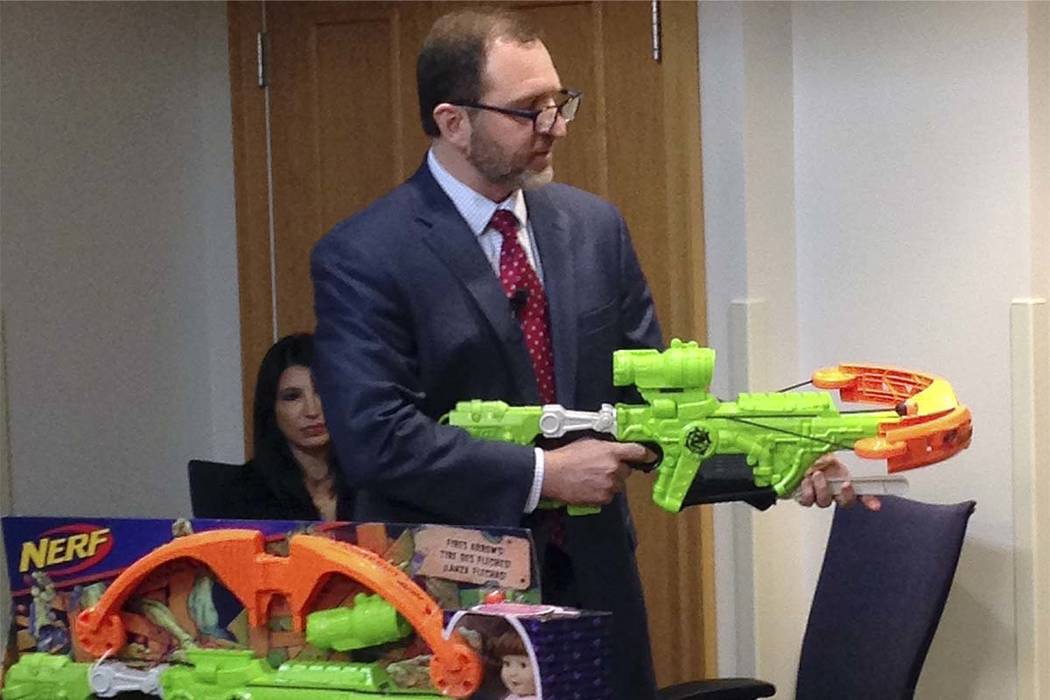 James Swartz, director of World Against Toys Causing Harm, or WATCH displays Nerf's "Zombie Strike" crossbow during a news conference Tuesday, Nov. 14, 2017, in Boston, where the child safety grou ...