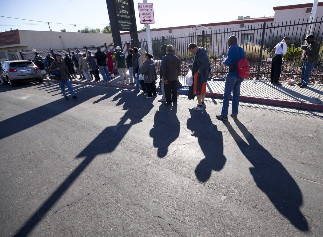 Homeless people wait for food handouts on Foremaster Lane between Las Vegas Boulevard and Main Street in Las Vegas, Wednesday, Nov. 22, 2017. Richard Brian Las Vegas Review-Journal @vegasphotograph