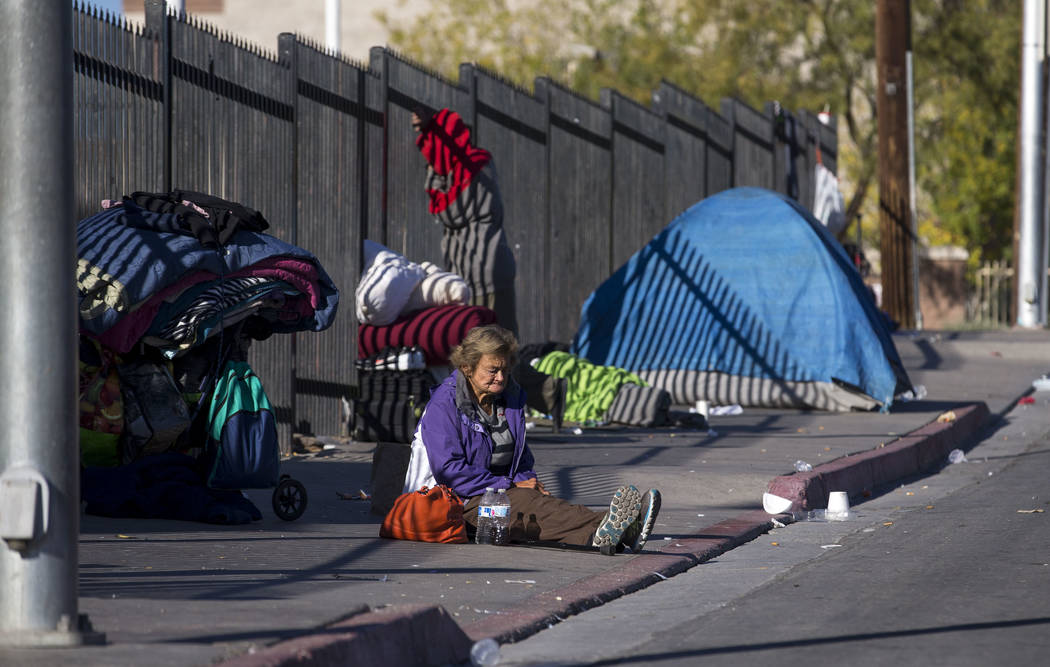 A homeless woman sits on the sidewalk on Foremaster Lane in Las Vegas, Wednesday, Nov. 22, 2017. Richard Brian Las Vegas Review-Journal @vegasphotograph