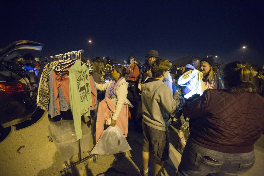 Individuals looks through clothes provided by the Compassion Initiate Las Vegas amongst other services off of H Street and Bonanza Road in Las Vegas, Monday, Nov. 20, 2017. Elizabeth Brumley Las V ...