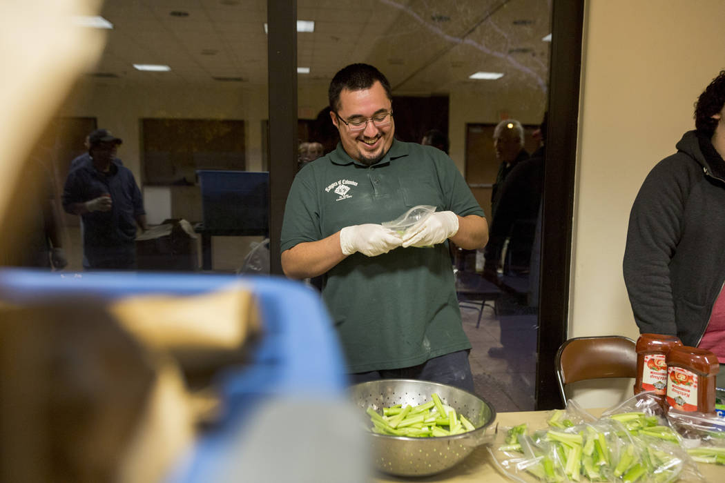 Knights Of Columbus councilmen Miguel Rosales packs dinners at Our Lady of Las Vegas to be given out to individuals in need in Las Vegas, Monday, Nov. 20, 2017.  Elizabeth Brumley Las Vegas Review ...