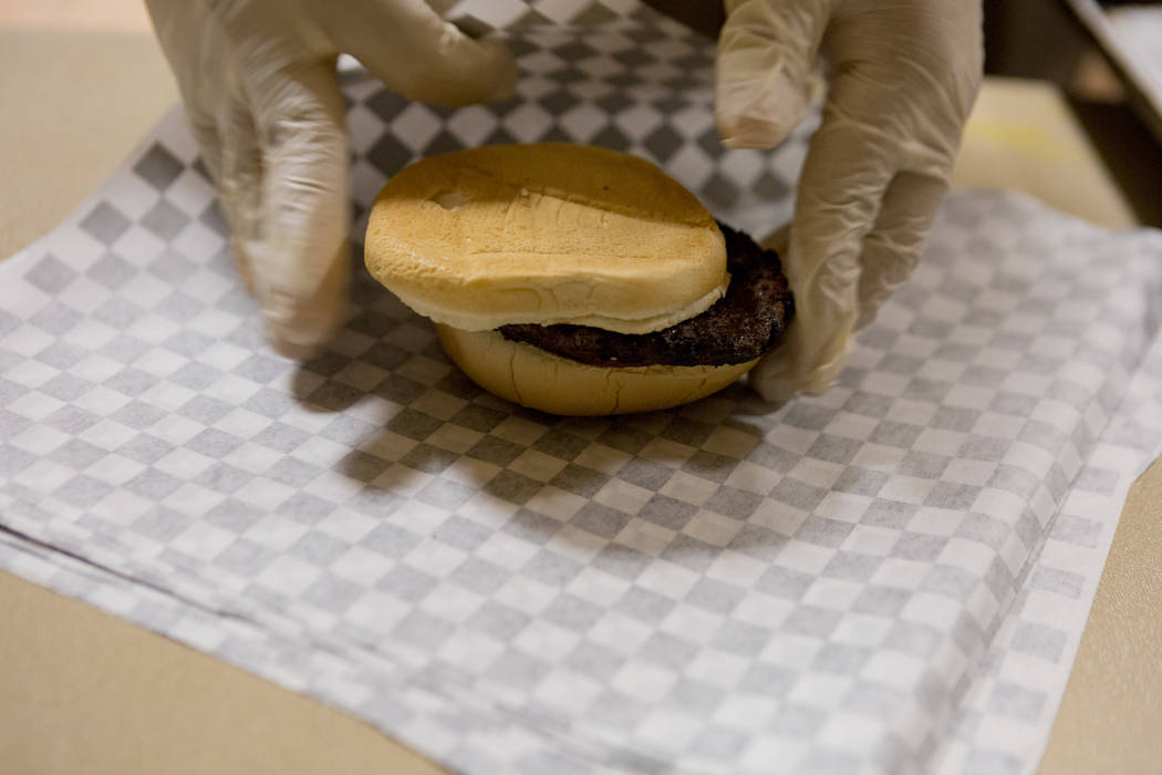 Knights Of Columbus councilmen wraps a hamburger at Our Lady of Las Vegas to be given out to individuals in need in Las Vegas, Monday, Nov. 20, 2017.  Elizabeth Brumley Las Vegas Review-Journal @E ...