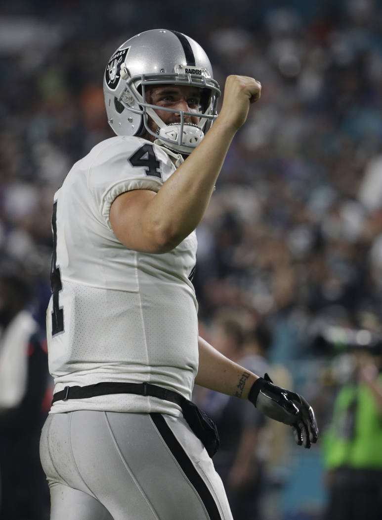 Oakland Raiders quarterback Derek Carr (4) gestures after his team scored a touchdown, during the second half of an NFL football game against the Miami Dolphins, Sunday, Nov. 5, 2017, in Miami Gar ...