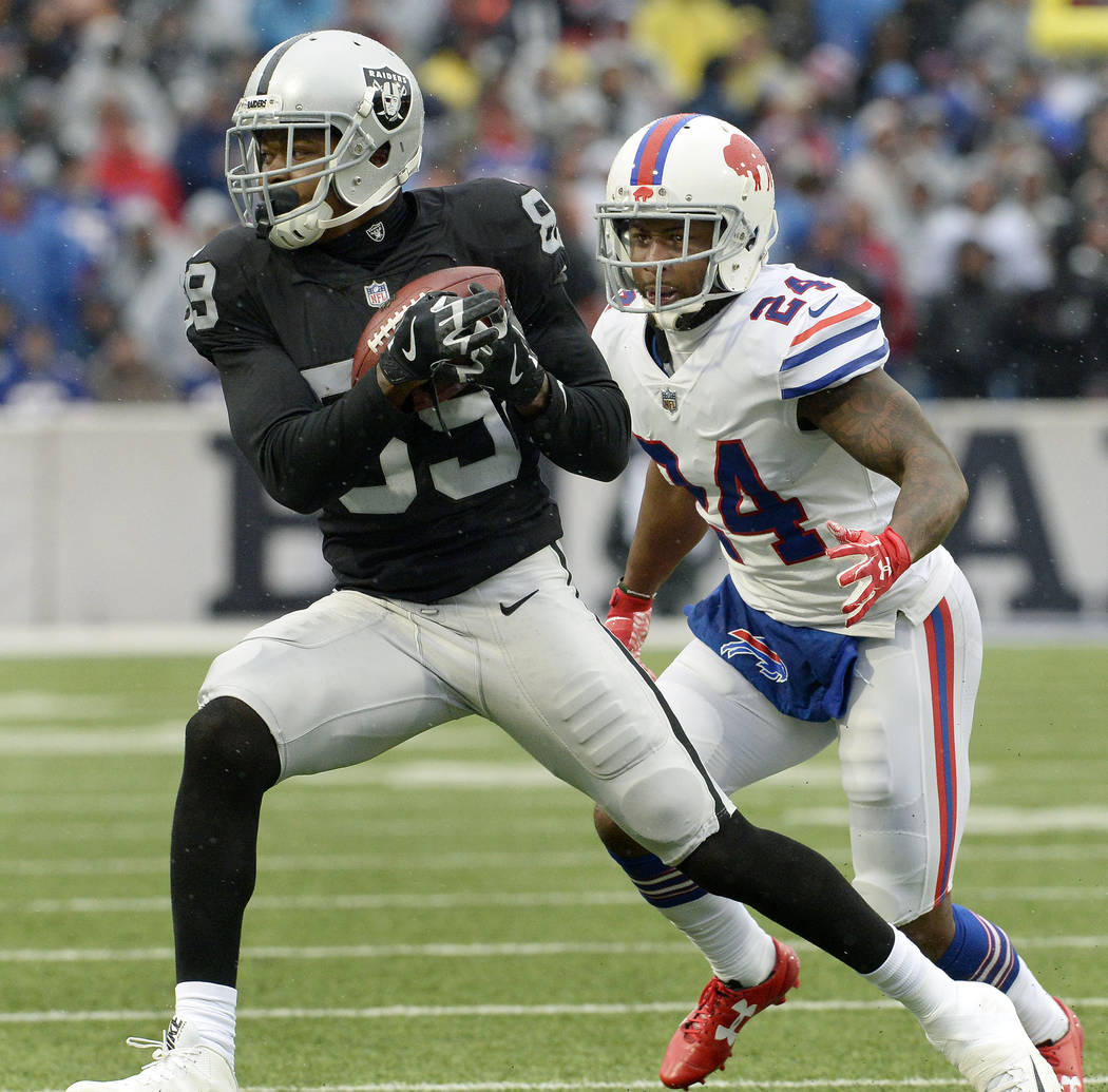 Oakland Raiders wide receiver Amari Cooper (89) makes a catch in front of Buffalo Bills cornerback Leonard Johnson (24) during the first half of an NFL football game, Sunday, Oct. 29, 2017, in Orc ...