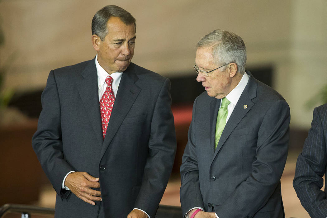 House Speaker John Boehner of Ohio, left, talks with Senate Majority Leader Harry Reid (D-Nev.) in Washington in 2014. (AP Photo/Evan Vucci)