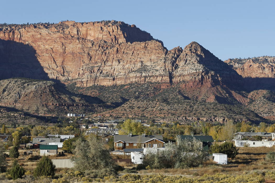 Hildale, Utah, is seen last month sitting at the base of Red Rock Cliff mountains, with its sister city, Colorado City, Ariz., in the foreground. (AP Photo/Rick Bowmer)