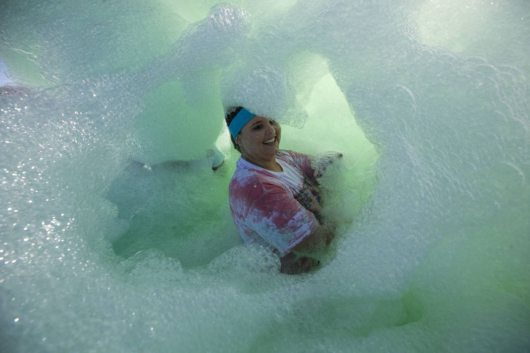 A participant is engulfed by green foam during the Bubble Run 5K event at Sam Boyd Stadium in Las Vegas, Saturday, Nov. 18, 2017. Richard Brian Las Vegas Review-Journal @vegasphotograph