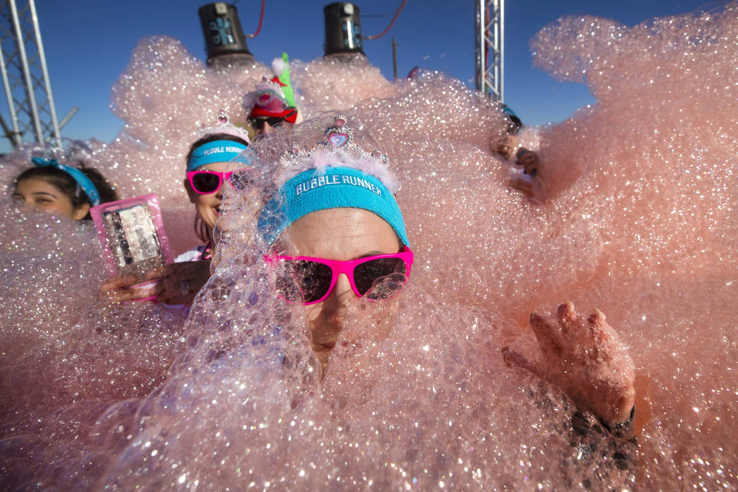Participants are engulfed by foam as they take part in the Bubble Run 5K event at Sam Boyd Stadium in Las Vegas, Saturday, Nov. 18, 2017. Richard Brian Las Vegas Review-Journal @vegasphotograph