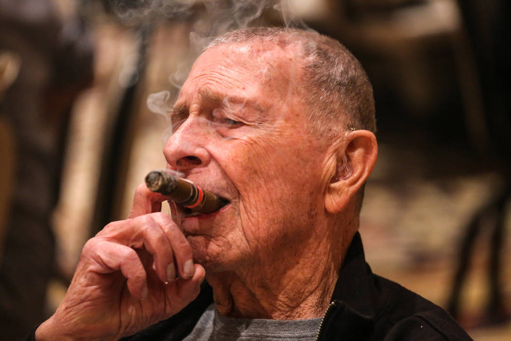 Jim Holler, 86, of Vista, Calif., smokes a cigar during the Cigar Aficionado's Big Smoke Las Vegas weekend event at The Mirage in Las Vegas, Saturday, Nov. 18, 2017. Joel Angel Juarez Las Vegas Re ...