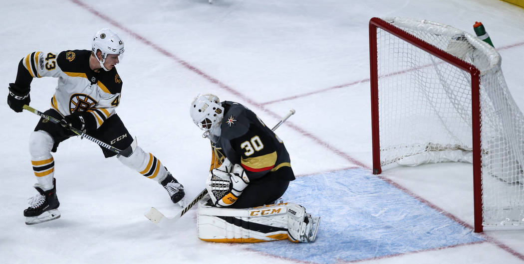Boston Bruins center Danton Heinen (43), left, attempts a shot as Vegas Golden Knights goalie Malcolm Subban (30), right, blocks it during the third period of an NHL hockey game at T-Mobile Arena  ...