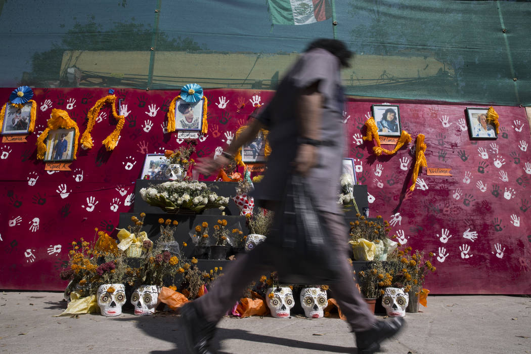 A memorial for the victims who died after their apartment complex, Unidad Habitacional de Tlalpan, collapsed during the Sept. 19 earthquake in Mexico City, Mexico, Friday, Nov. 17, 2017. Erik Verd ...
