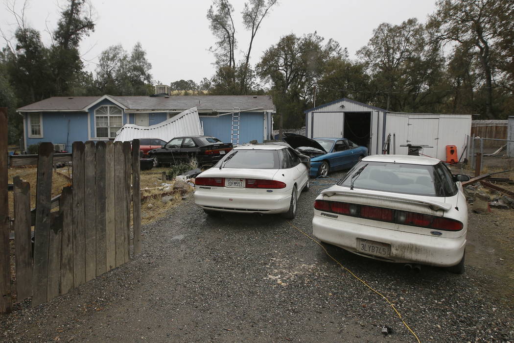 Cars are parked in front of the home of Kevin Janson Neal Wednesday, Nov. 15, 2017, in Rancho Tehama Reserve, Calif. (AP Photo/Rich Pedroncelli)