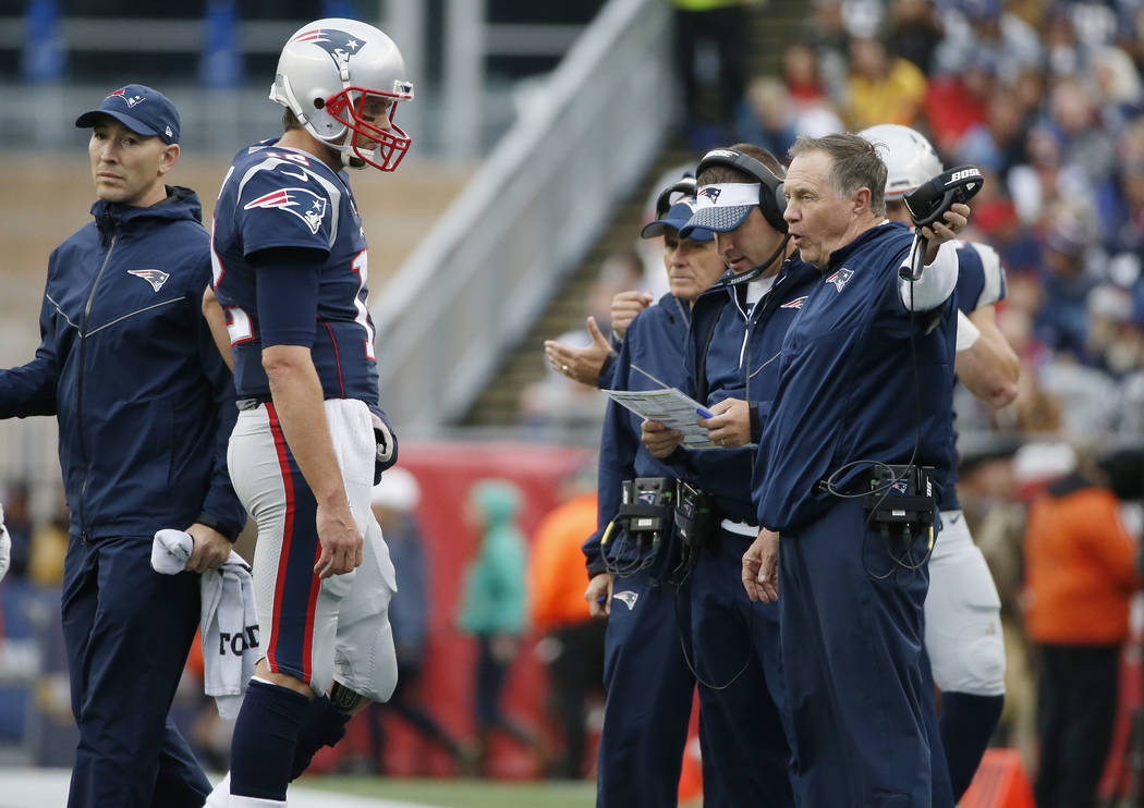 New England Patriots head coach Bill Belichick, right, instructs New England Patriots quarterback Tom Brady, left, during the second half of an NFL football game against the Los Angeles Chargers, ...