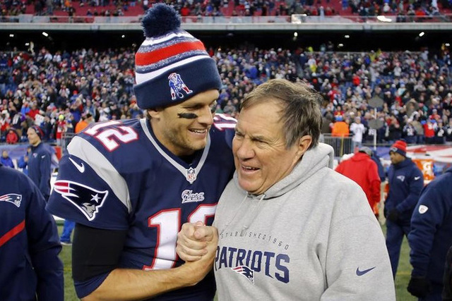 New England Patriots quarterback Tom Brady (12) celebrates with head coach Bill Belichick (R) after clinching the AFC East title with a 41-13 win over the Miami Dolphins at Gillette Stadium. Manda ...