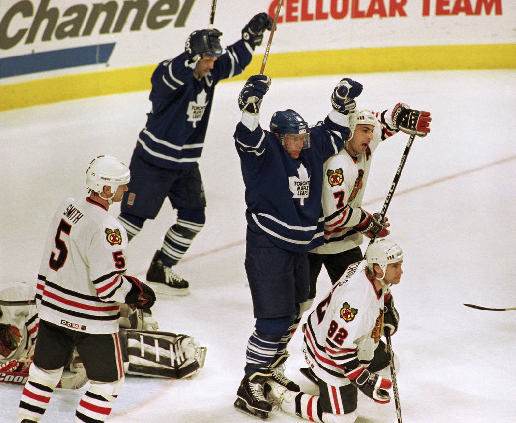 Toronto Maple Leafs' Mats Sundin celebrates over Chicago Blackhawks' Chris Chelios (7) and Bernie Nicholls after Dave Andreychuk's first period goal, Friday, May 19, 1995, in Game 7 of the Western ...