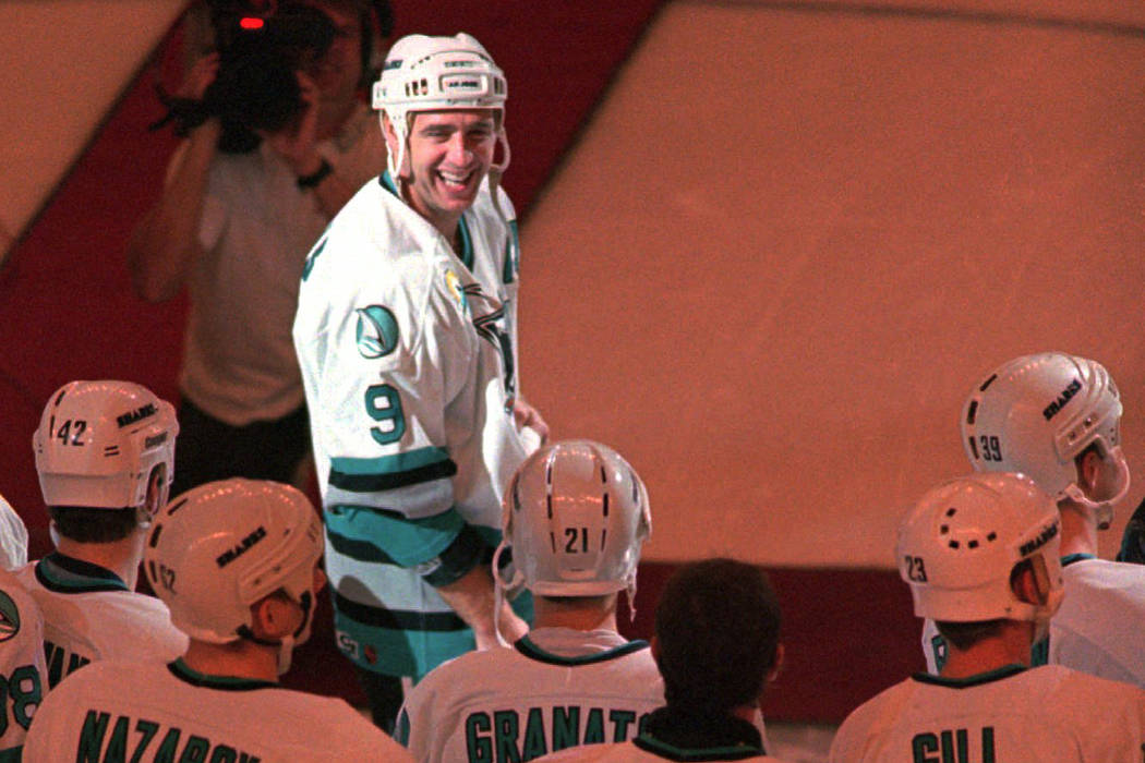 San Jose Sharks center Bernie Nicholls is surrounded by his teammates as they celebrate his 1,000th NHL game, Saturday night, Nov. 2, 1996, during a pre-game ceremony before the Sharks game agains ...