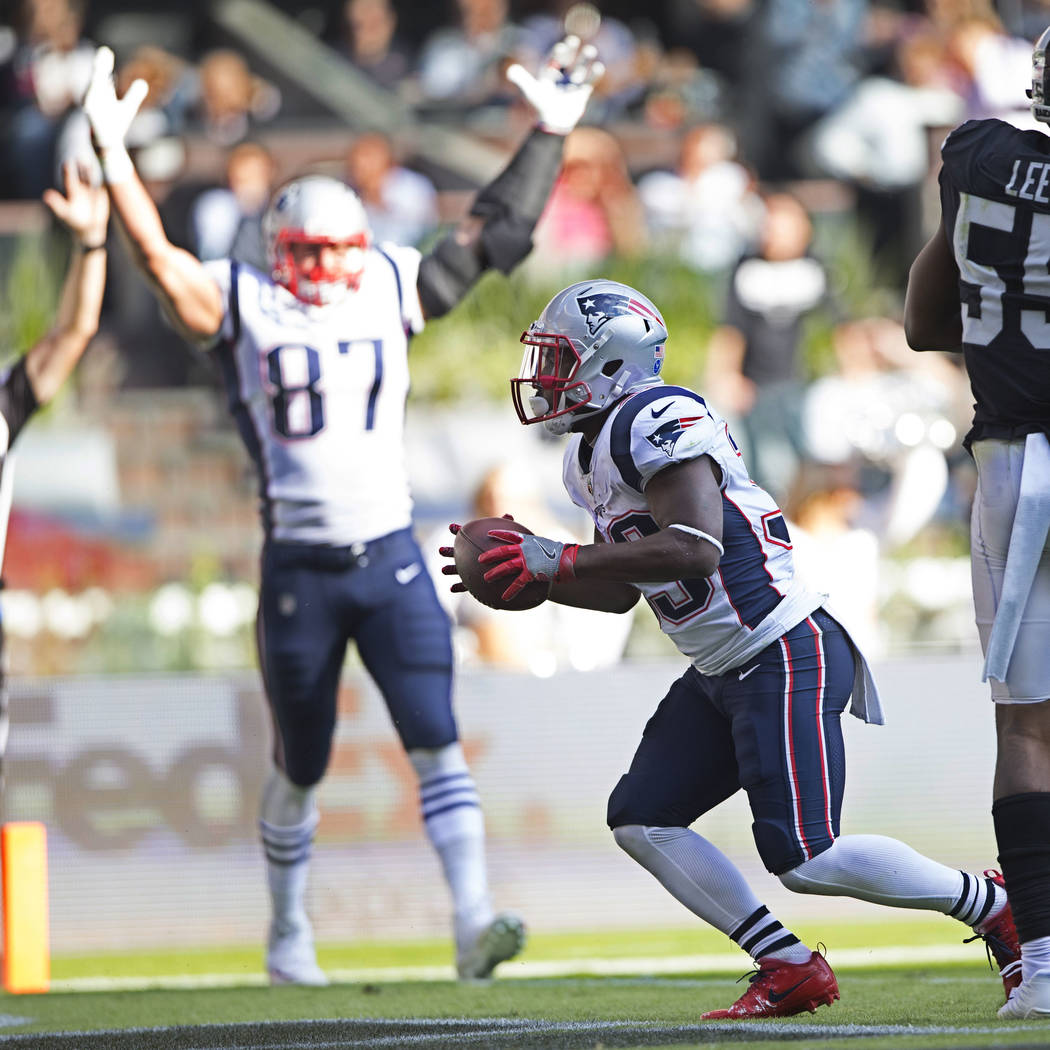 New England Patriots running back Dion Lewis (33) celebrates a touchdown against the Oakland Raiders in the NFL football game at Estadio Azteca in Mexico City, Sunday, Nov. 19, 2017. Erik Verduzco ...
