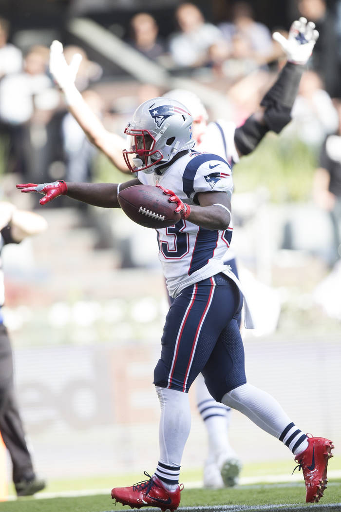New England Patriots running back Dion Lewis (33) celebrate his touchdown against the Oakland Raiders in the NFL football game at Estadio Azteca in Mexico City, Sunday, Nov. 19, 2017. Erik Verduzc ...