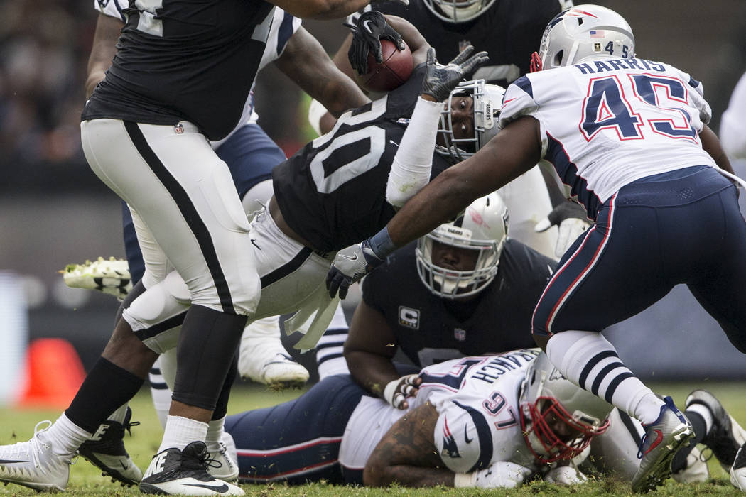 Oakland Raiders running back Jalen Richard (30) runs the ball against the New England Patriots in the NFL football game at Estadio Azteca in Mexico City, Sunday, Nov. 19, 2017. Erik Verduzco Las V ...
